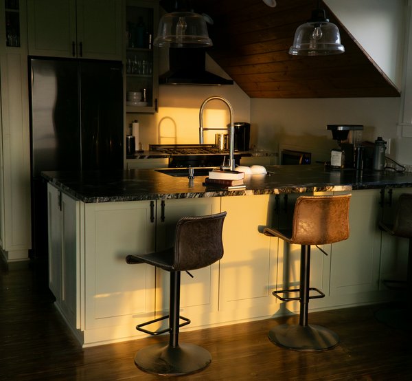 What are the essential tools and appliances for a raw food kitchen in a health-focused restaurant?